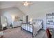Bright bedroom with a high ceiling, a wrought iron bed frame, and stylish decor at 5315 Hidden Valley Ln, Cumming, GA 30028