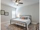 Cozy bedroom with a wrought iron bed, patterned rug, and natural light from the window at 5315 Hidden Valley Ln, Cumming, GA 30028