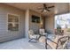 A covered patio with furniture, ceiling fan, and outdoor television provides space for relaxation at 5315 Hidden Valley Ln, Cumming, GA 30028