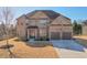 Beautiful two-story brick home with a well-manicured lawn and a two-car garage at 5315 Hidden Valley Ln, Cumming, GA 30028