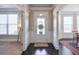 Welcoming foyer with dark hardwood floors, white wainscoting, and natural light at 5315 Hidden Valley Ln, Cumming, GA 30028