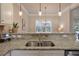 Granite countertops accent this kitchen sink area with its stainless steel sink and gooseneck faucet at 5315 Hidden Valley Ln, Cumming, GA 30028
