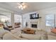 Open-concept living room with fireplace, shiplap accent wall, and seamless flow to the dining and kitchen areas at 5315 Hidden Valley Ln, Cumming, GA 30028