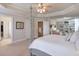 Spacious main bedroom with sitting area, built-in bookshelves, and four-poster bed at 5315 Hidden Valley Ln, Cumming, GA 30028