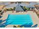 Aerial view of the community swimming pool, surrounded by lounge chairs and umbrellas at 5315 Hidden Valley Ln, Cumming, GA 30028