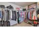 Well-organized walk-in closet with hanging racks, shelves, and space for shoes and luggage at 5315 Hidden Valley Ln, Cumming, GA 30028