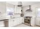 Well-lit kitchen with white cabinets, stainless steel appliances, marble countertops, and subway tile backsplash at 603 Terry Se St, Atlanta, GA 30312