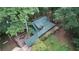 Aerial view of a charming home surrounded by lush trees, showcasing its metal roof and inviting wooden deck space at 6245 Bannister Rd, Cumming, GA 30028