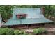 Aerial view of the cabin home showcasing the roof and surrounding trees at 6245 Bannister Rd, Cumming, GA 30028