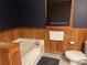 A bathroom with wood trim and white fixtures at 6245 Bannister Rd, Cumming, GA 30028