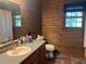 Bathroom features wood paneled walls and a single sink vanity at 6245 Bannister Rd, Cumming, GA 30028