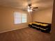 A simple bedroom with a ceiling fan and a window bringing in natural light at 6245 Bannister Rd, Cumming, GA 30028