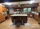 A kitchen with a large kitchen island and wooden cabinets at 6245 Bannister Rd, Cumming, GA 30028