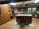 A kitchen with a large kitchen island and wooden cabinets at 6245 Bannister Rd, Cumming, GA 30028