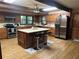 A large kitchen with wood floors and cabinets and stainless steel appliances at 6245 Bannister Rd, Cumming, GA 30028