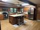 Well-equipped kitchen with stainless steel appliances, an island with seating, and ample cabinet space for storage at 6245 Bannister Rd, Cumming, GA 30028