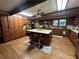 Traditional kitchen with wood cabinets, island, and hardwood floors at 6245 Bannister Rd, Cumming, GA 30028