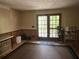 A spacious living room with french doors to the outdoor patio with wainscotting at 6245 Bannister Rd, Cumming, GA 30028