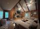 Inviting living room featuring wood paneled walls, a stone fireplace, and comfortable seating, creating a cozy atmosphere at 6245 Bannister Rd, Cumming, GA 30028