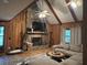 Cozy living room featuring wood paneled walls, a stone fireplace, and comfortable seating, creating a cozy atmosphere at 6245 Bannister Rd, Cumming, GA 30028