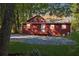 Spacious backyard with a gravel area, back porch, and mature trees providing shade at 7880 Rivertown Rd, Atlanta, GA 30213