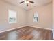 A minimalistic bedroom featuring hardwood floors, ceiling fan, and neutral paint at 7880 Rivertown Rd, Atlanta, GA 30213