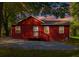 Red home with gravel driveway and a small red deck at 7880 Rivertown Rd, Atlanta, GA 30213