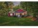 Charming front yard of a cozy red home, featuring a well-manicured lawn and inviting porch at 7880 Rivertown Rd, Atlanta, GA 30213