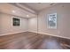 An empty room featuring hardwood floors and neutral paint awaiting your personal design and furnishings at 7880 Rivertown Rd, Atlanta, GA 30213