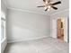 Serene bedroom with neutral carpet, ceiling fan, and a glimpse into the ensuite bathroom at 549 Henry Dr, Marietta, GA 30064