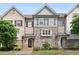 Charming townhome featuring a blend of brick and stone with stylish shutter accents at 549 Henry Dr, Marietta, GA 30064