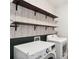 Functional laundry room with floating shelves and modern washer and dryer at 549 Henry Dr, Marietta, GA 30064