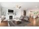 Bright living room with fireplace, built-ins, ceiling fan, and hardwood floors leading to the open kitchen at 549 Henry Dr, Marietta, GA 30064