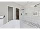 Luxurious bathroom featuring walk-in shower, modern tiling and fixtures, and soaking tub at 1081 Napier Se St, Atlanta, GA 30316