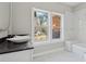 Modern bathroom features a unique vanity and marble-look tile throughout at 1081 Napier Se St, Atlanta, GA 30316