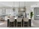 Chic kitchen island with barstools, stainless steel appliances, and modern pendant lighting at 1081 Napier Se St, Atlanta, GA 30316