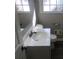 Bathroom featuring a modern sink, toilet, and window with natural light at 3387 Forest Hill Rd, Powder Springs, GA 30127