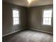 Comfortable bedroom with neutral colors, new carpet, and two bright windows at 3387 Forest Hill Rd, Powder Springs, GA 30127