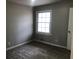 Simple bedroom with gray carpet, and one window at 3387 Forest Hill Rd, Powder Springs, GA 30127