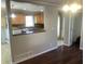 Dining room view showing granite counters, wooden cabinets, and a tiled floor entrance at 3387 Forest Hill Rd, Powder Springs, GA 30127