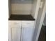 Hallway cabinet with white cabinets and drawers, plus dark countertop for extra storage at 3387 Forest Hill Rd, Powder Springs, GA 30127