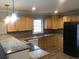 Bright kitchen with wooden cabinets, modern appliances, granite counters, and plenty of natural light at 3387 Forest Hill Rd, Powder Springs, GA 30127