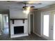 Inviting living room with a cozy fireplace, ceiling fan, and access to the backyard at 3387 Forest Hill Rd, Powder Springs, GA 30127