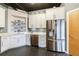 Well-lit kitchen with stainless steel appliances, white cabinets, and concrete floors at 395 Central Park Ne Pl # 420, Atlanta, GA 30312