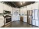 Modern kitchen featuring stainless steel appliances, white cabinets, and concrete floors at 395 Central Park Ne Pl # 420, Atlanta, GA 30312