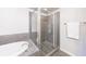 Tiled shower with glass doors next to a tub at 395 Central Park Ne Pl # 420, Atlanta, GA 30312