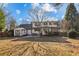 Backyard view of a two-story home with green shutters, brick patio, and shed at 5352 Waterford Dr, Dunwoody, GA 30338