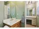 Bathroom featuring a wood vanity, a large mirror, and two-room layout with a small vanity desk at 5352 Waterford Dr, Dunwoody, GA 30338