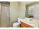 Bathroom featuring gold trim, a wood vanity, a large mirror, and a shower with glass doors at 5352 Waterford Dr, Dunwoody, GA 30338