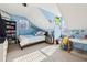 Attic bedroom featuring blue walls, neutral carpet, desk, and a sloped ceiling at 5352 Waterford Dr, Dunwoody, GA 30338